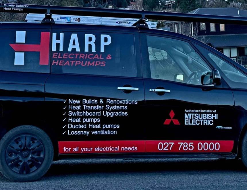 Close view of the van signage listing new builds, heat transfer, switchboard upgrades, heat pumps, ducted heat pumps and Lossnay ventilation